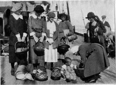 Women giving out fruit baskets